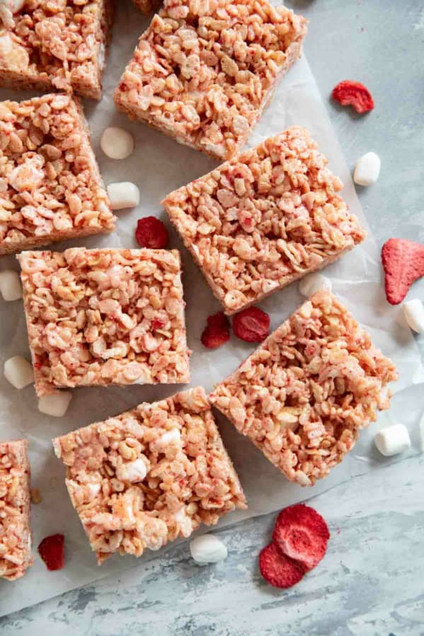 Strawberry Rice Krispie Treats cut into bars, with freeze dried strawberries and mini marshmallows.