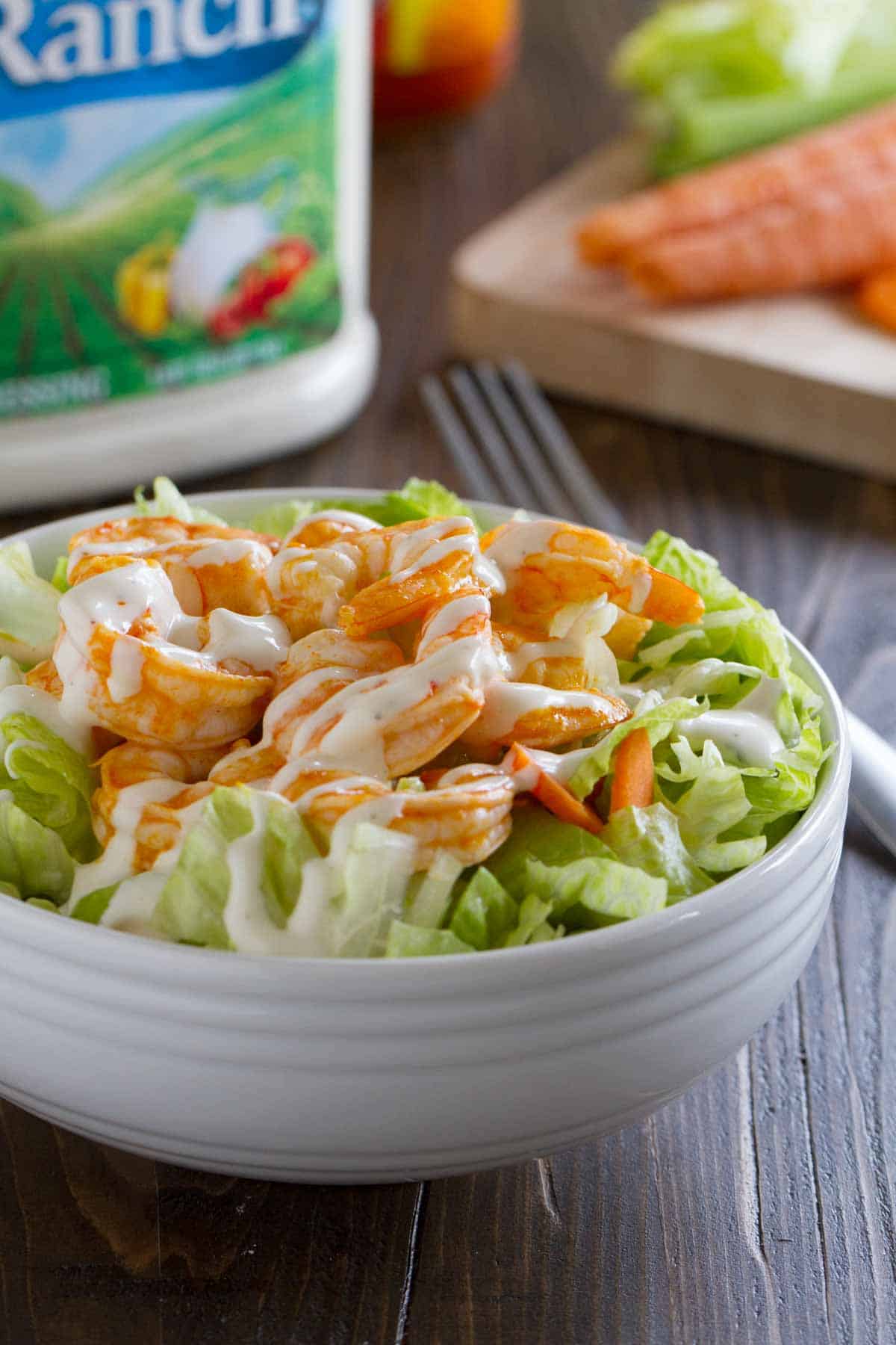 Buffalo Ranch Shrimp Salad topped with easy buffalo shrimp.