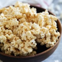 Wooden bowl filled with caramel marshmallow popcorn.