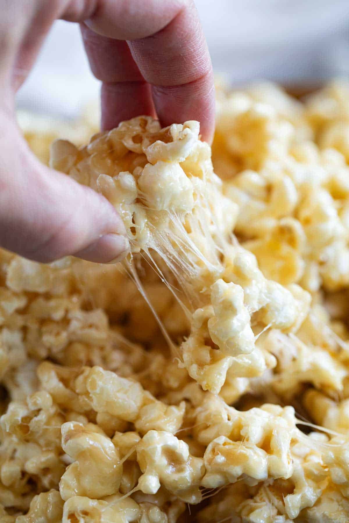 Pulling on gooey caramel marshmallow popcorn.