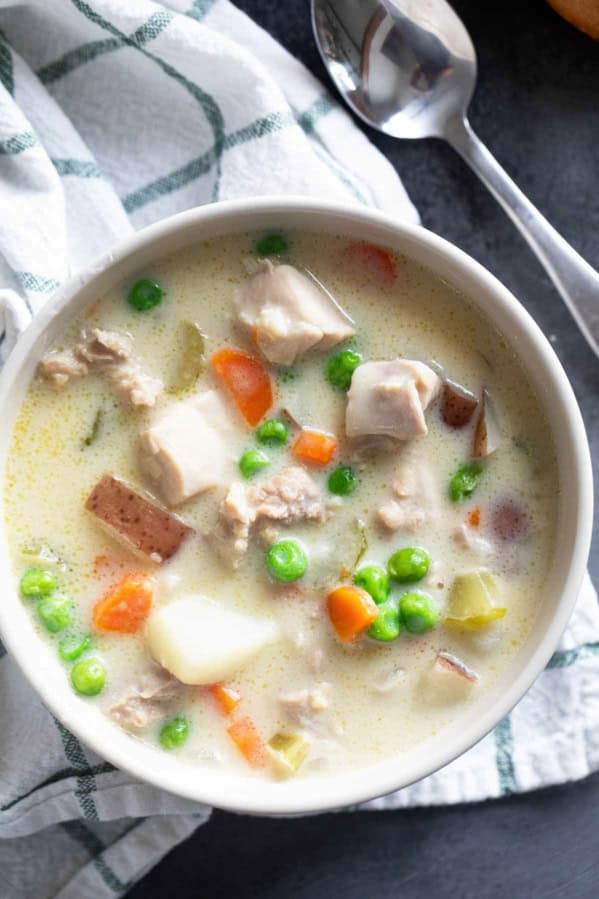 Bowl of chicken stew with chicken thighs, potatoes, and vegetables.