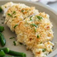 Crunchy Mayo Chicken cut into slices and topped with parsley.