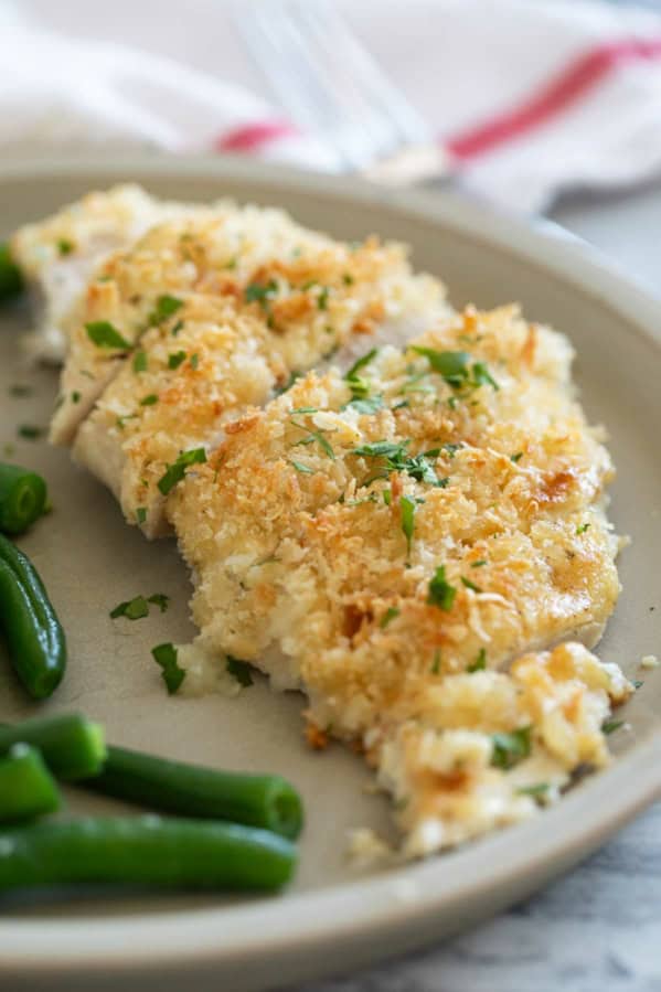 Crunchy Mayo Chicken cut into slices and topped with parsley.