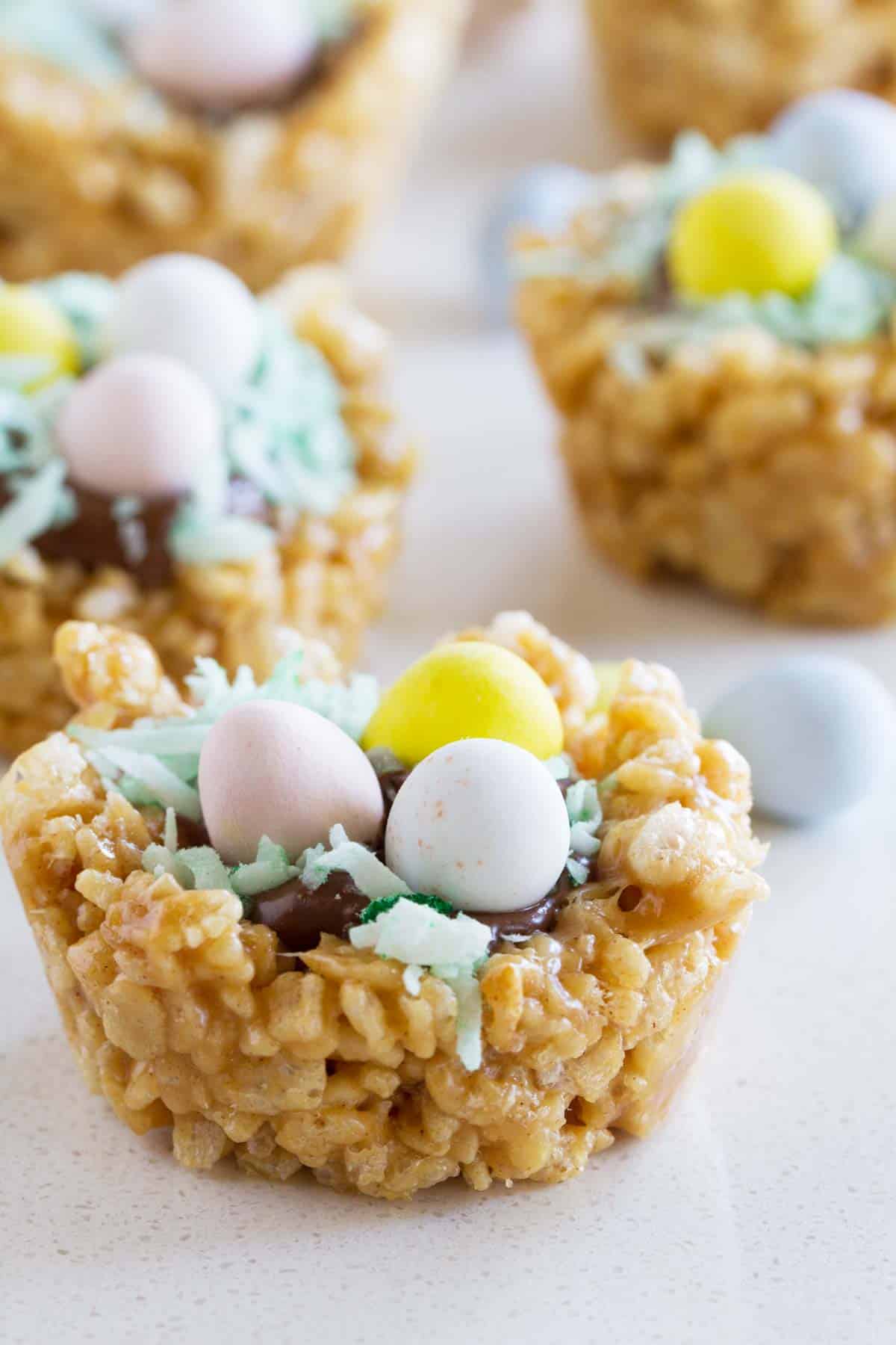 Easter Basket Scotcheroos topped with chocolate, coconut, and chocolate eggs.