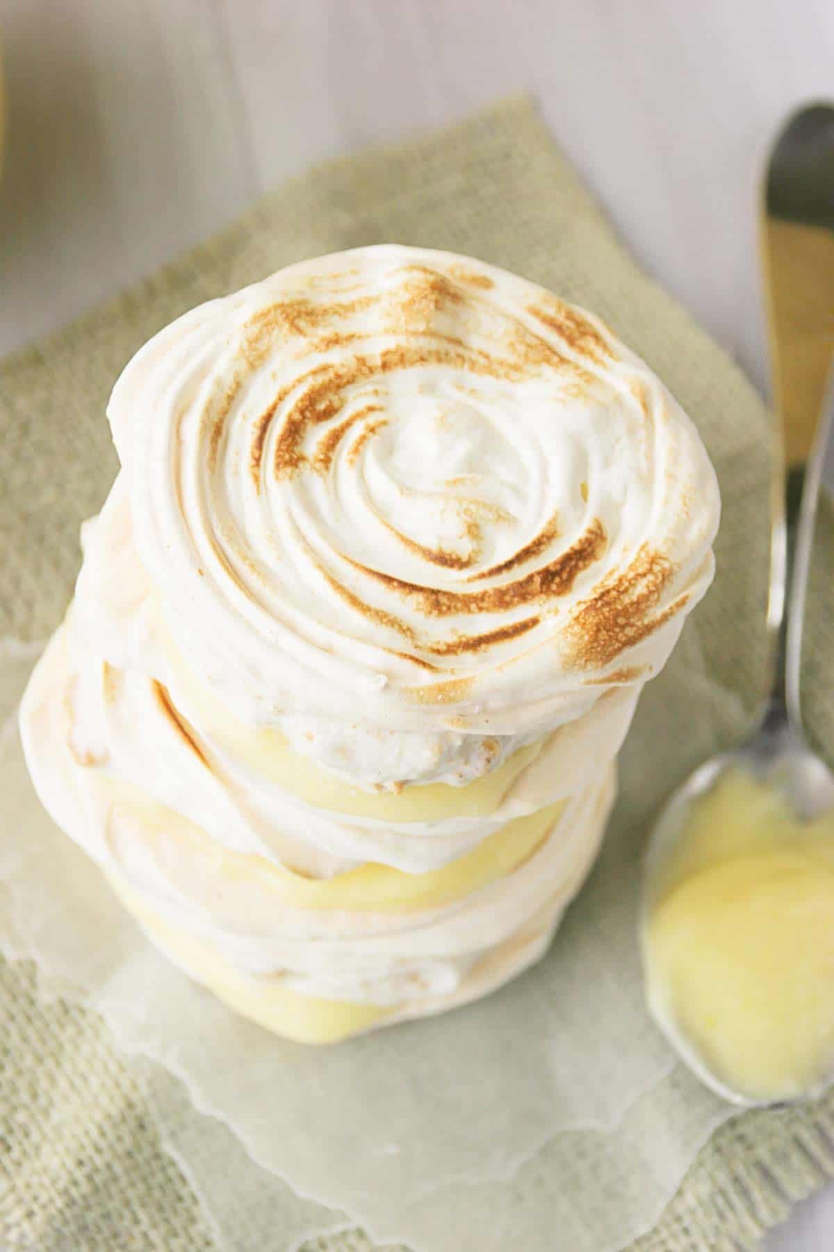 Lemon Meringue Hand Pies stacked, showing the browned edges of the cookie.