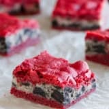 Oreo Cream Cheese Stuffed Red Velvet Brownies on a piece of white parchment paper.