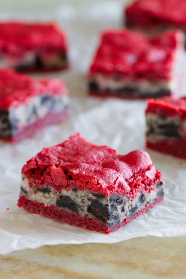 Oreo Cream Cheese Stuffed Red Velvet Brownies on a piece of white parchment paper.