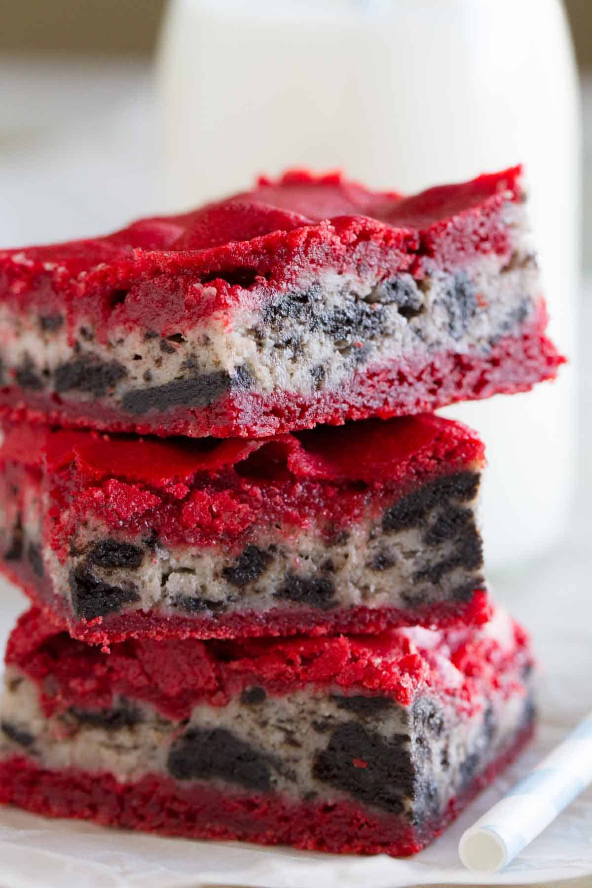 Three Oreo Cream Cheese Stuffed Red Velvet Brownies stacked on top of each other.