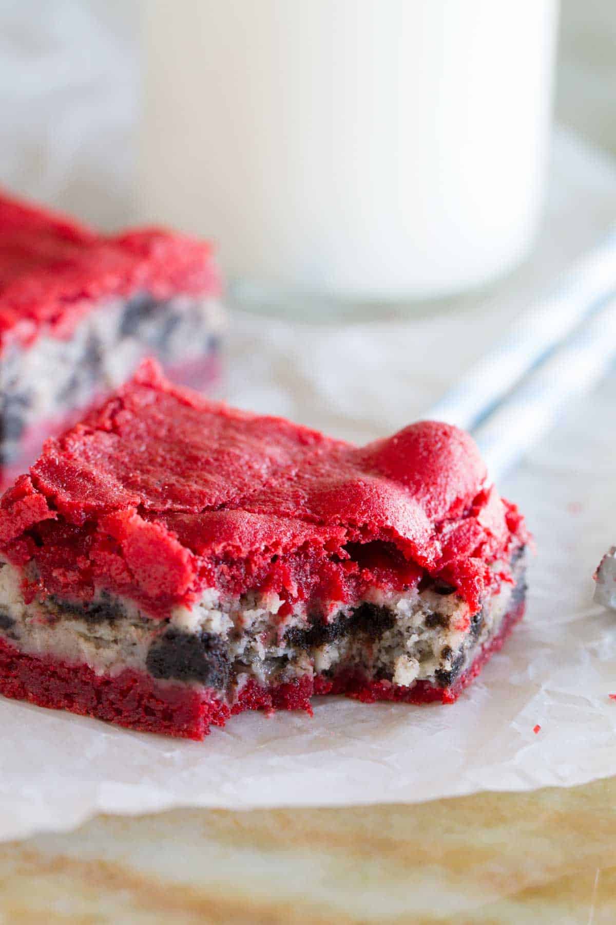 Oreo Cream Cheese Stuffed Red Velvet Brownie with a bite taken from it.