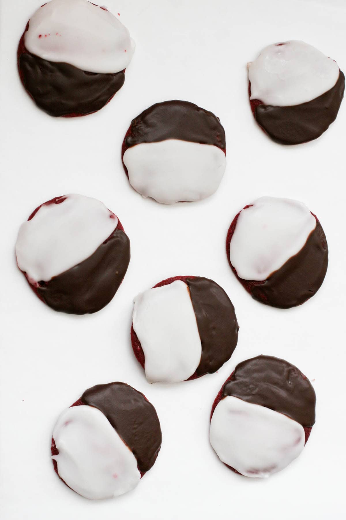 Red velvet black and white cookies on a white background.