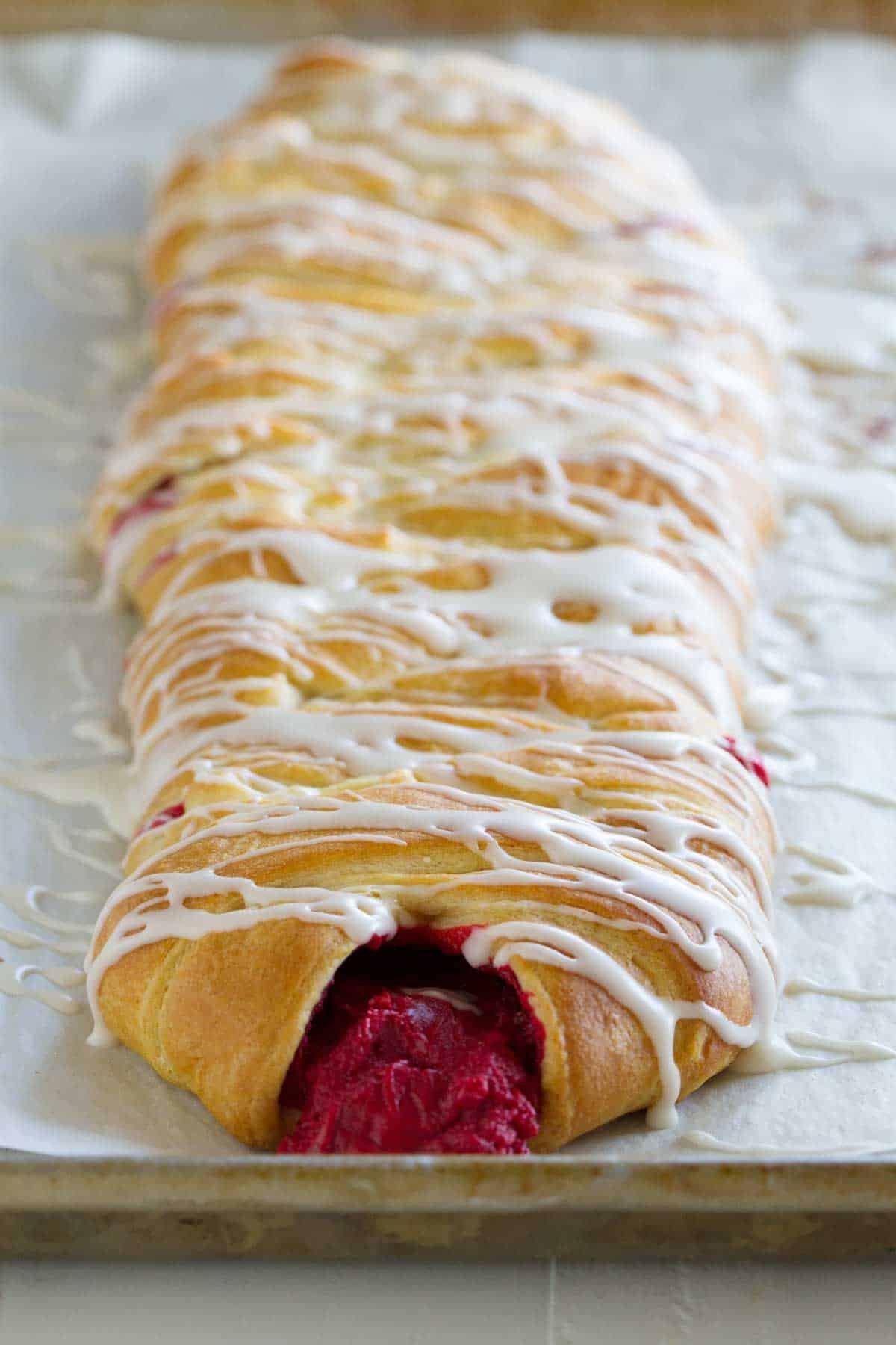 Red Velvet Cream Cheese Danish with glaze on top.