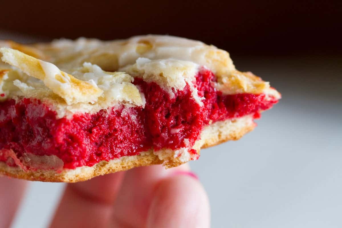 Red Velvet Cream Cheese Danish with a bite taken from it.