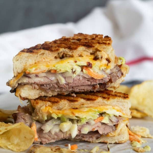 Roast beef panini cut in half and stacked on top of each other.