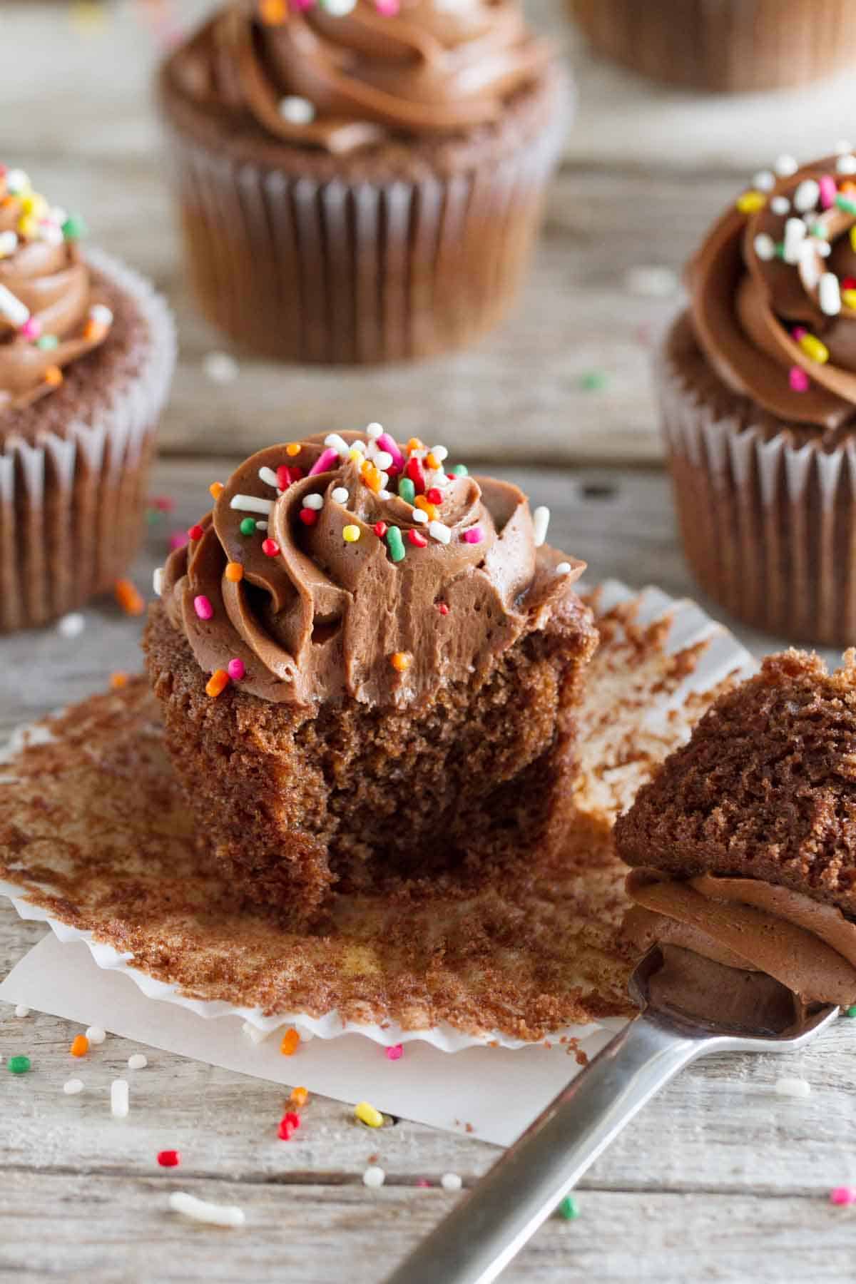 Chocolate Sour Cream Cupcakes with Chocolate Buttercream with a bite taken from a cupcake.