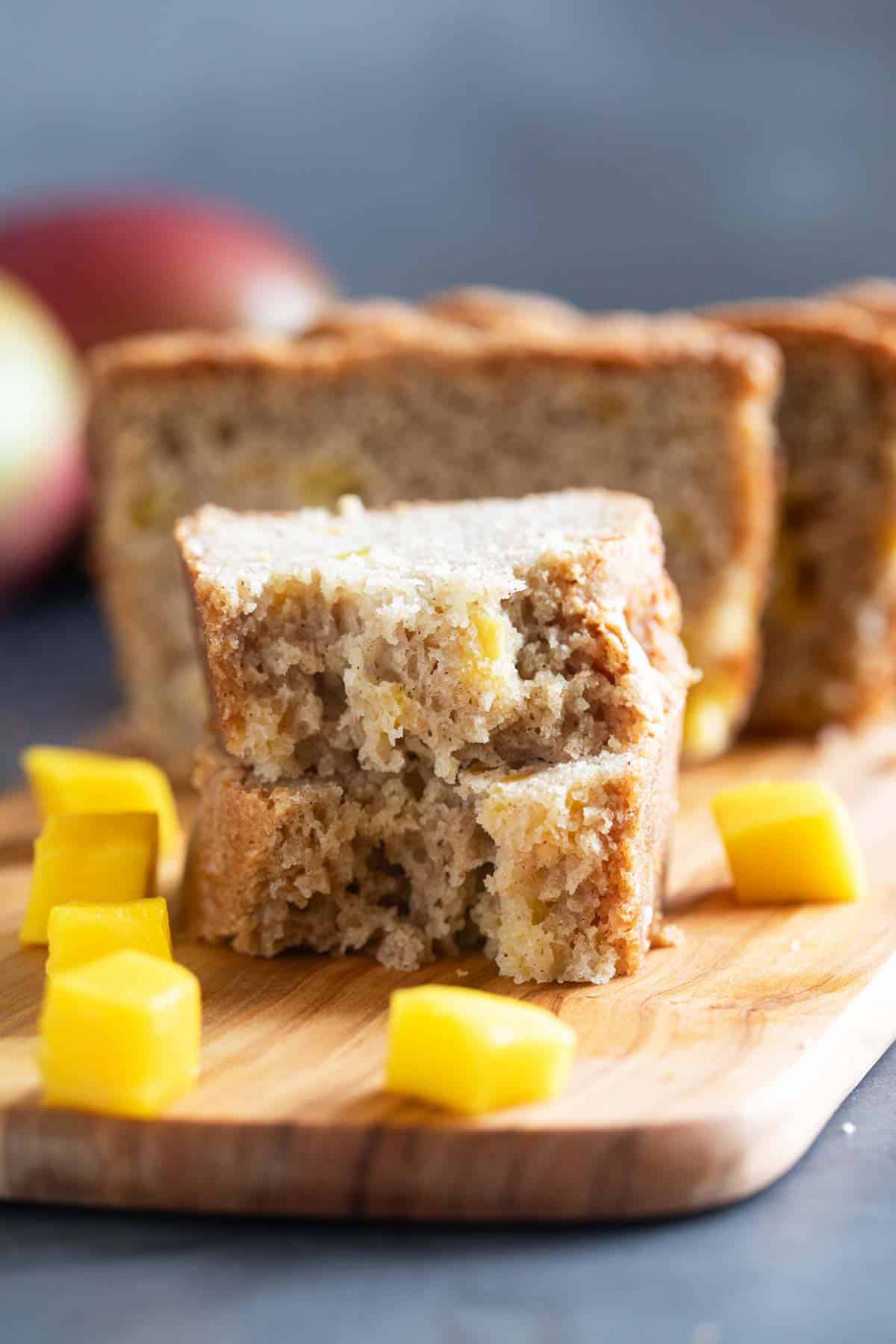 Slice of mango bread broken in half and stacked.