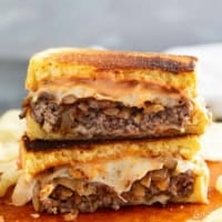 Patty Melt cut in half and stacked.