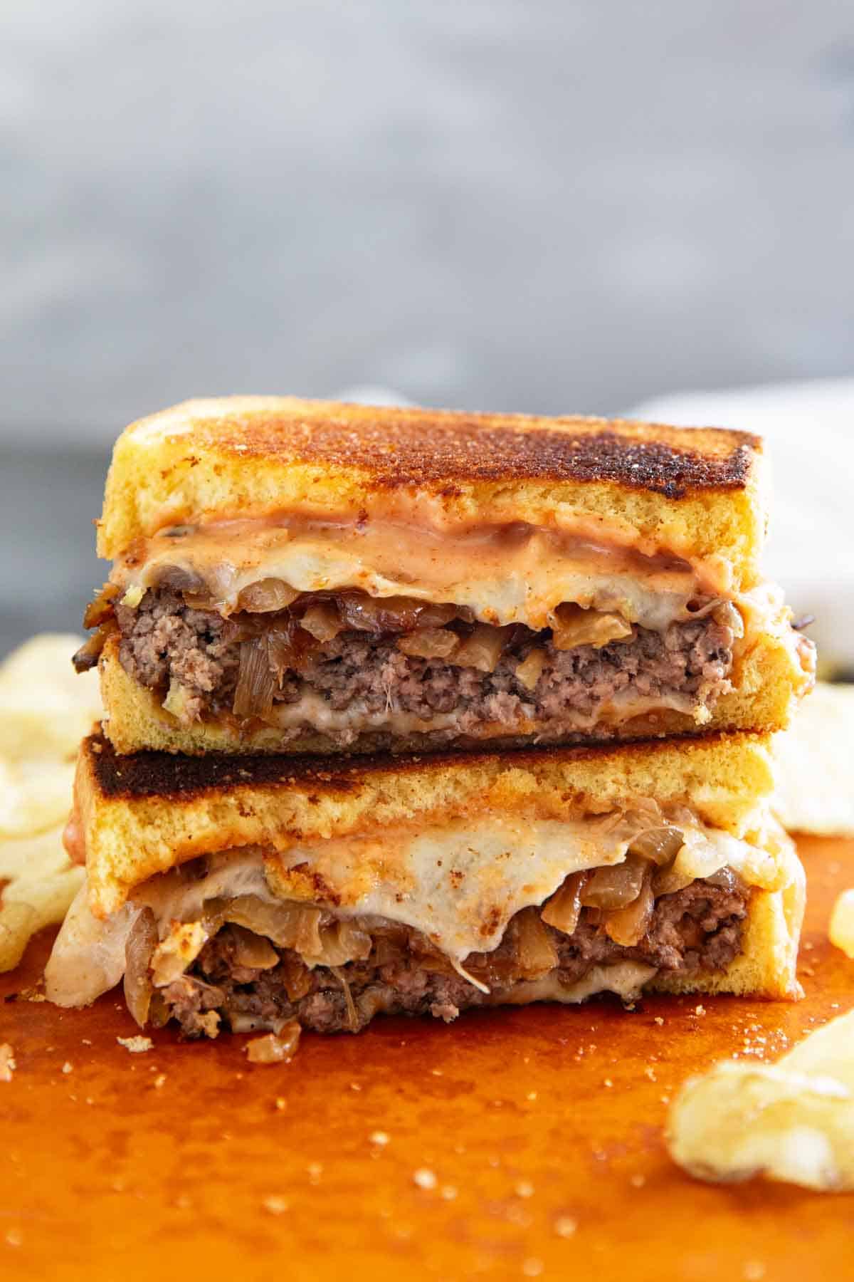 Patty Melt cut in half and stacked.